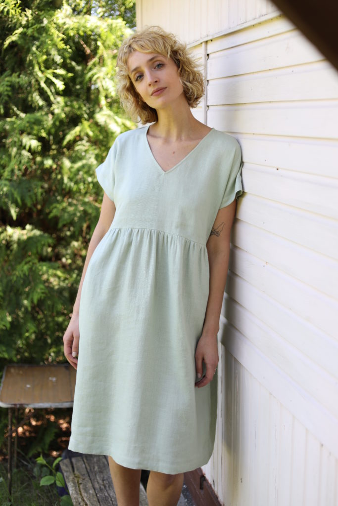 V-neck linen dress in sage green color - Image 1